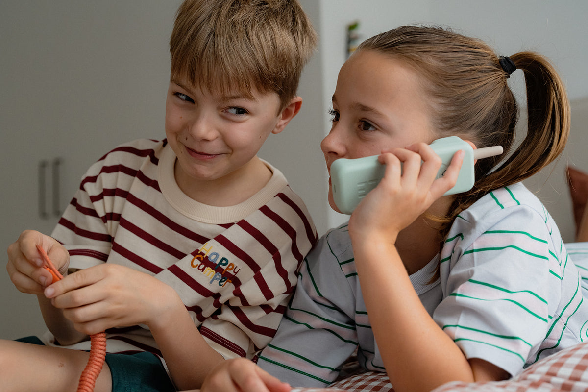 Kids making a call on the Waffle Home mint green