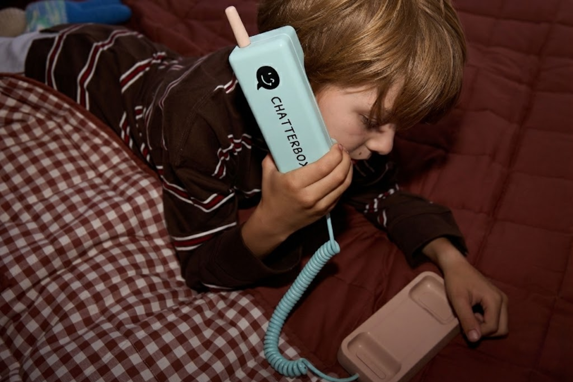Child using Waffle screen-free kids phone outdoors